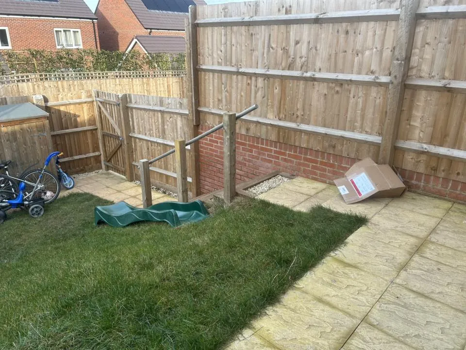 Rustic red wooden fence with a metal latch, ensuring safety and security outdoors.